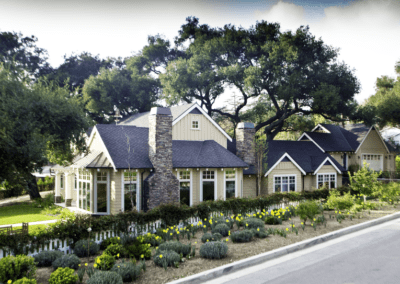 Suburban house with a stone facade and landscaped garden.